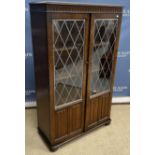 A 20th Century mahogany corner cupboard in the Georgian style with astragal glazed upper door over