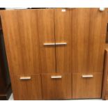 A modern cherry wood veneered stationery cabinet with two cupboard doors enclosing a shelf over