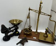 A set of Victorian brass scales and weights on a mahogany base,