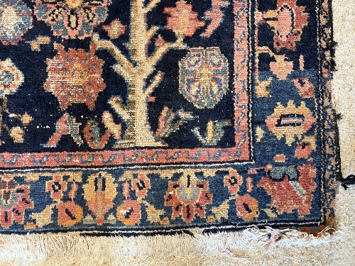 A Persian rug, the central panel set with all-over floral motifs on a dark blue ground, - Image 59 of 66