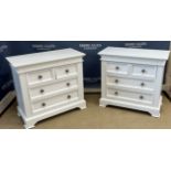 A pair of modern white wood chests of two short over two long drawers with metal knob handles,