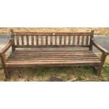 A modern teak garden bench seat bearing plaque inscribed "Made by the Hughes Bolckow Ship Breaking