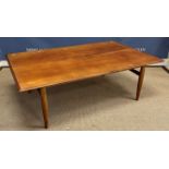 A mid 20th Century Danish teak coffee table on tapering turned legs united by end stretchers