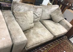 A modern mushroom or taupe upholstered four seat sofa on block supports 245 cm wide x 102 cm deep x