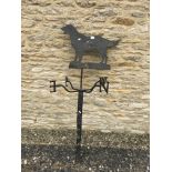 A black painted wrought iron weather vane of typical form with Retriever figure decoration,