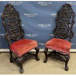 A pair of 19th Century carved oak hall chairs in the 17th Century Flemish taste,
