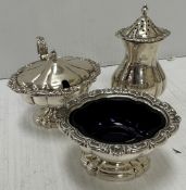 A Queen Elizabeth II silver three piece cruet in the early 19th Century manner,