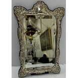 A modern silver framed easel back mirror in the Victorian manner with embossed floral decoration
