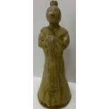 A Chinese pale green / yellow glazed pottery figure of an attendant in the Song dynasty manner with