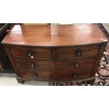 A Victorian mahogany bow fronted chest of two short over two long drawers with turned knob handles