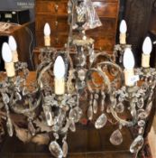 A French brass eight branch electrolier with hanging lustre drops 108 cm long