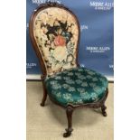 A Victorian floral carved rosewood framed spoon back salon chair with needlework upholstered back
