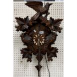 A modern Black Forest type cuckoo clock of typical form decorated with birds amongst foliage, 37.