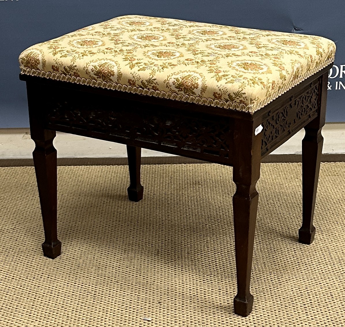 A Victorian upholstered rectangular footstool on mahogany cabriole legs to scroll feet,