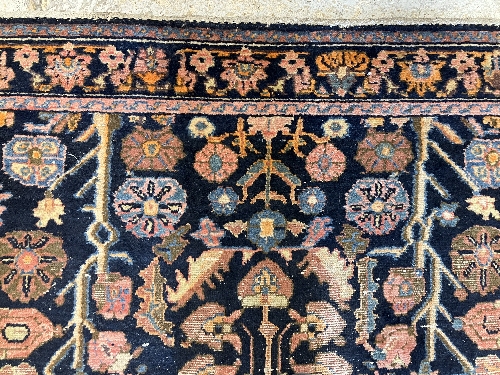 A Persian rug, the central panel set with all-over floral motifs on a dark blue ground, - Image 64 of 66