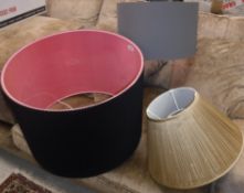 A large black corrugated lampshade with pink inner 55 cm diameter x 40 cm high together with a