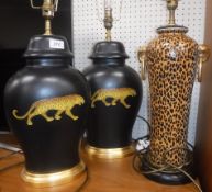 A pair of modern Rochamp black ground panther decorated table lamps 48 cm high including fittings
