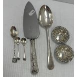 A collection of silver wares to include a tablespoon, pair of salt spoons,