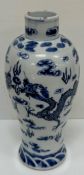 A Chinese blue and white baluster shaped vase decorated with four toed air dragons chasing a pearl
