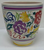 A Poole Pottery vase with bird amongst flowers decoration raised on a circular foot 18 cm diameter