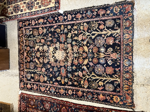 A Persian rug, the central panel set with all-over floral motifs on a dark blue ground, - Image 66 of 66