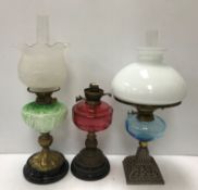 A collection of five various Victorian and later oil table lamps,