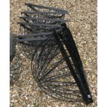 A collection of eight black plastic covered wrought iron hay rack type planters, wall-mounted,