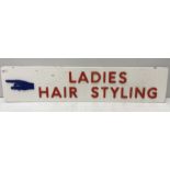 A mid 20th Century PVC sign with figure pointing left inscribed "Ladies Hair Styling" 66 cm x 14.