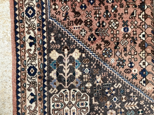 A Persian rug, the central panel set with all-over floral motifs on a dark blue ground, - Image 39 of 66