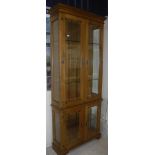 A modern oak glazed four door display cabinet on bracket feet 94.5 cm wide x 32.