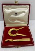 A Goldsmiths & Silversmiths for Asprey & Company Ltd gold plated two piece bottle opener set in