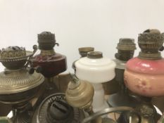 Nine various Victorian and later oil lamps, a milk glass oil lamp base,