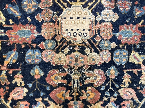 A Persian rug, the central panel set with all-over floral motifs on a dark blue ground, - Image 62 of 66