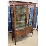 An Edwardian mahogany and inlaid serpentine fronted display cabinet,