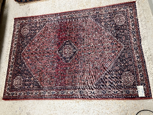 A Persian rug, the central panel set with all-over floral motifs on a dark blue ground, - Image 30 of 66