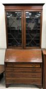 An Edwardian mahogany and satinwood banded bureau bookcase in the Sheraton Revival taste, the top