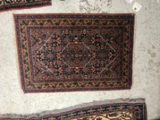 A Shenna rug, the central panel set with lozenge shaped medallion and all over stylised floral