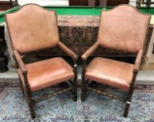 A pair of studded leather covered oak framed open arm throne type chairs in the 17th Century style
