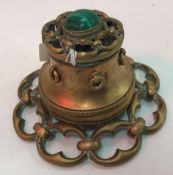 A Victorian brass inkwell with ornate chainlink banded decoration in openwork to the base and
