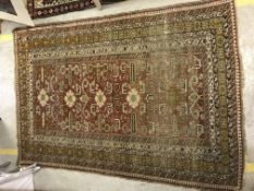 A Caucasian rug, the central panel set with stylised floral and animal motifs on a red ground within
