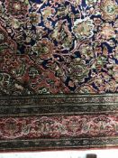 A fine Kashan silk rug, the central panel set with foliate decorated medallion on a blue and