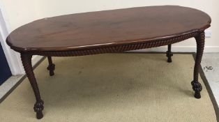 A modern mahogany shaped oval dining table in the 19th Century style, the plain top with moulded
