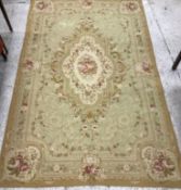 An Aubusson carpet, the central panel set with floral decorated medallion on a pale green and