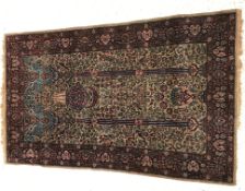 An Oriental prayer rug of Mihrab style d