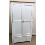 A modern white wood wardrobe with two cu