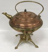 A copper and brass kettle on stand by Be