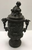 A cast metal bronzed urn with bacchanali