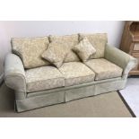 A modern faun floral upholstered three s