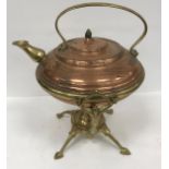 A copper and brass kettle on stand by Be