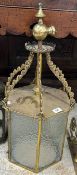 A brass hexagonal lantern with glass pan